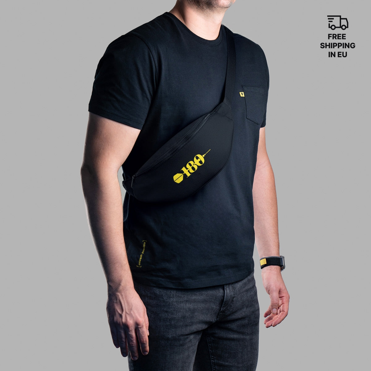 Person wearing a black sling bag with a yellow 180 logo