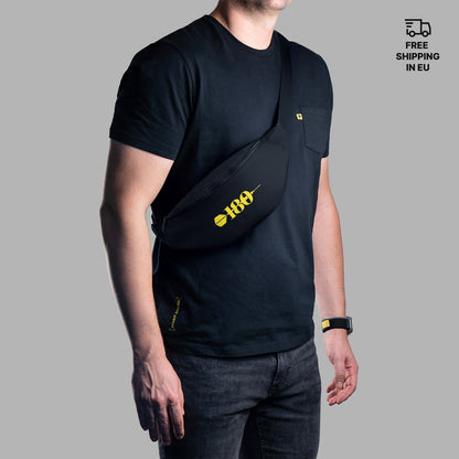 Person wearing a black sling bag with a yellow 180 logo